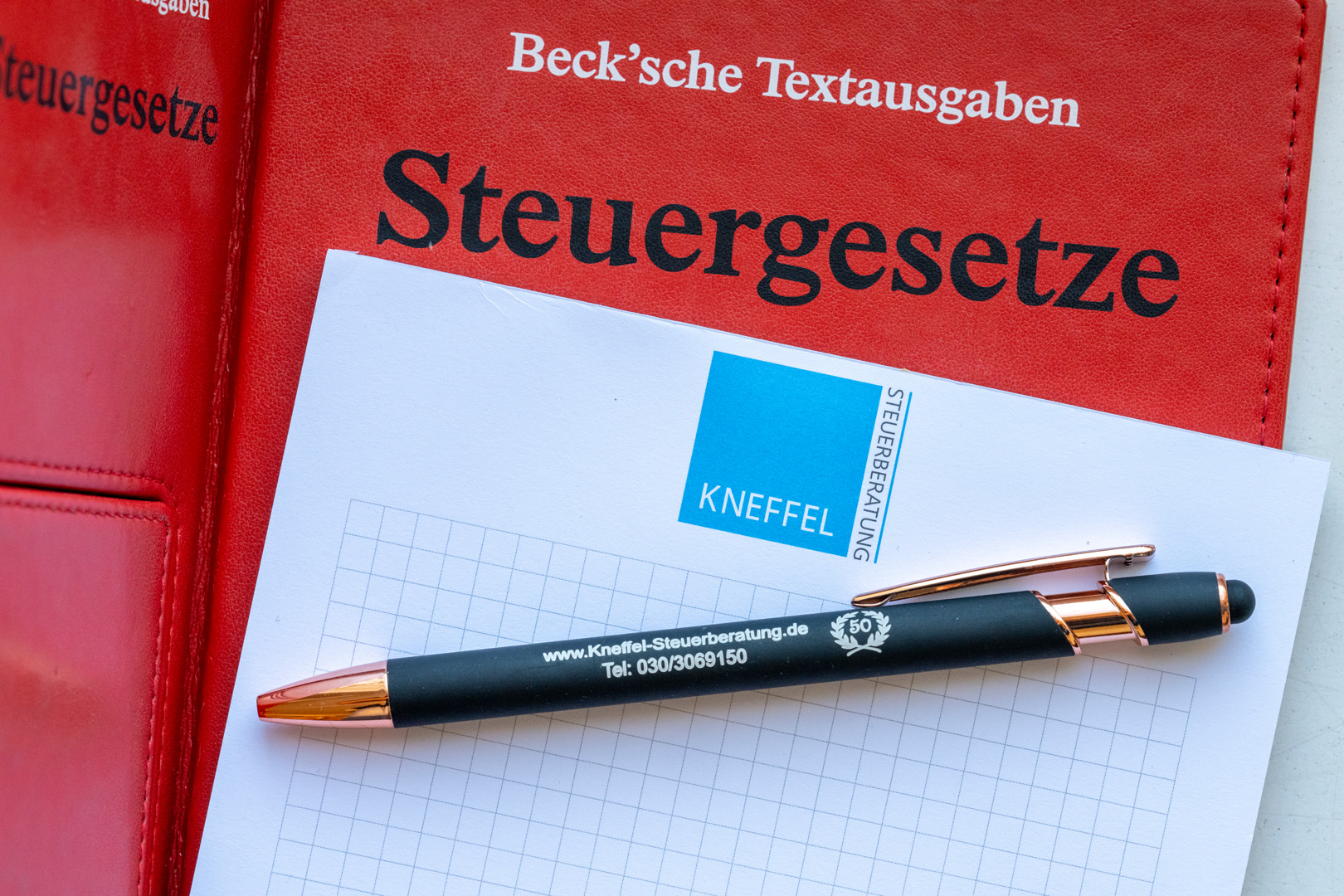 Steuergesetze und Kanzlei-Notizblock mit Stift